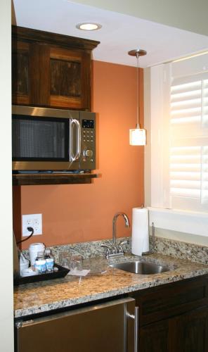 a kitchen with a sink and a microwave at Showers Inn in Bloomington