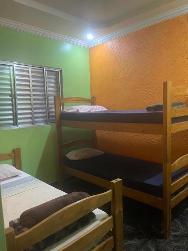 a room with three bunk beds in it at Hotel e Pousada Porto Forte in São Paulo