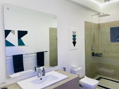 a bathroom with a sink and a toilet at Josan Villa with a Glorious Beach and Sea View in Habaraduwa Central