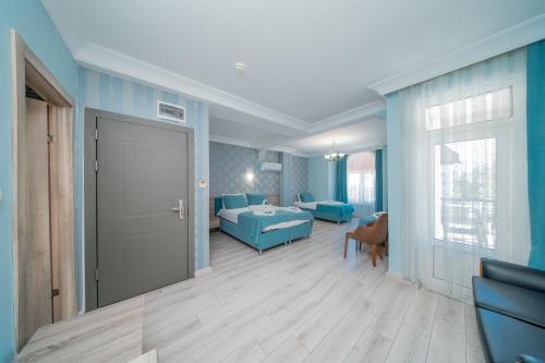 a room with blue walls and a room with a door at Sava Hotel in Antalya