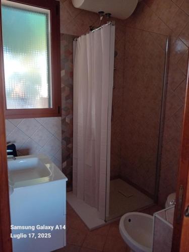 a bathroom with a shower and a sink at Casa SILMAGA in La Maddalena