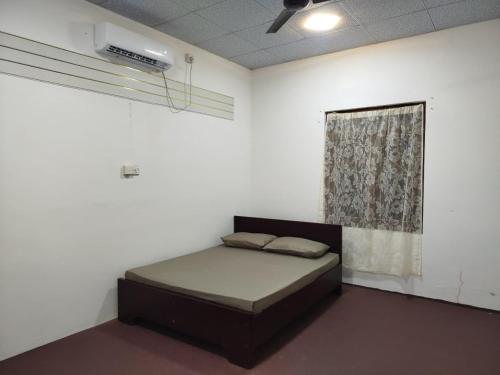a bedroom with a bed in a room with a window at Aqua Dream Adventures Resort in Trincomalee