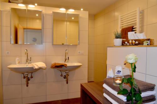 a bathroom with two sinks and a mirror at Bauernhof König in Zwiesel
