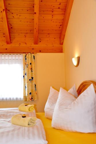 a bedroom with a bed with two towels on it at Bauernhof König in Zwiesel