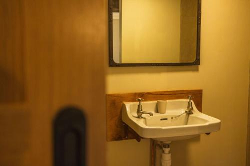 a bathroom with a sink and a mirror at The Dairy in Lifton