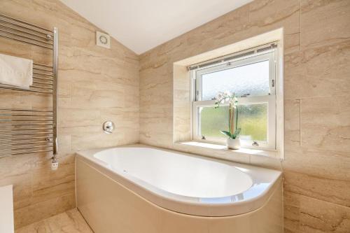 a bath tub in a bathroom with a window at 3 Bed in Gunnerside oc-ds097 in Gunnerside