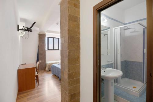 a bathroom with a shower and a sink at B&B H Pompeii Ruins in Pompei
