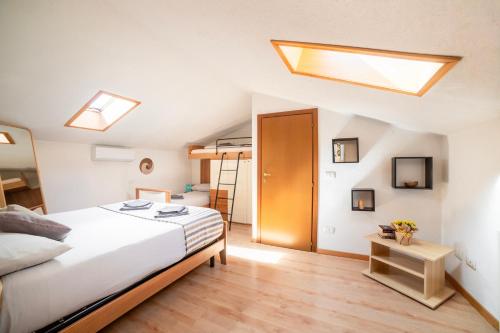 a bedroom with a bed and a skylight at Camping Italia 90 Two Levels Apartment in Domaso