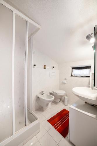 a bathroom with a shower and a toilet and a sink at Camping Italia 90 Two Levels Apartment in Domaso
