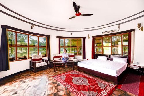 a woman standing in a bedroom with a bed at Hotel Goram Garh Resort in Pāli