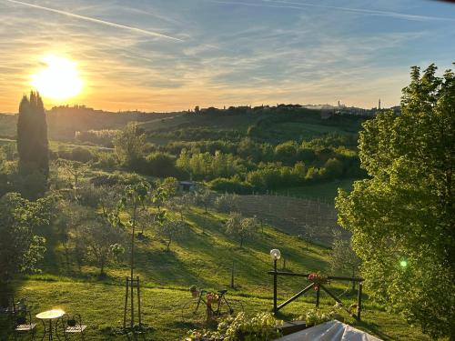 a view of a field with the sun in the sky at Agriturismo La Corte del Sole in Siena