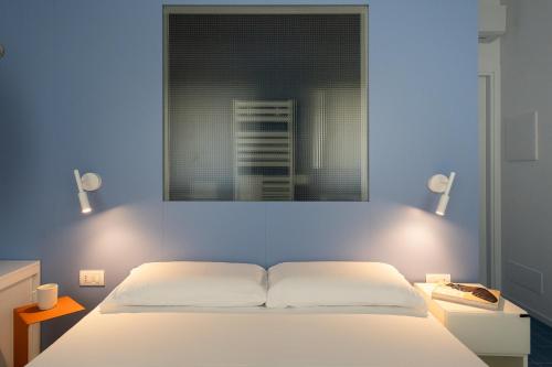 a bedroom with a white bed and a window at VIVO Rooms in Civitanova Marche