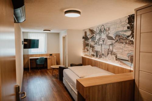 a bedroom with a bed and a painting on the wall at Braustube Wehle in Dunningen