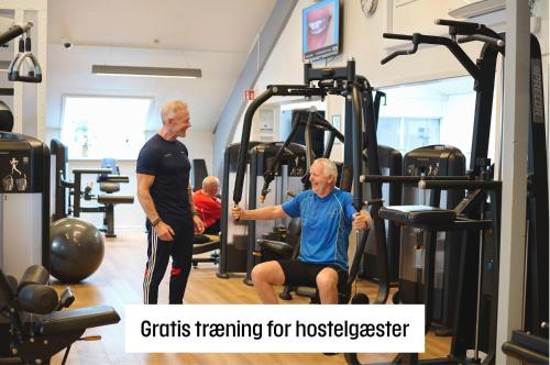 two men in a gym with the words gifts training for housekeeper at Fyrtårn Tommerup Hostel in Tommerup