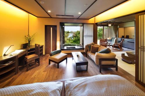 a living room with a couch and a table at Noto Hyakurakusou in Ogi