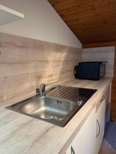 a kitchen counter with a sink and a microwave at Haus Raimund in Längenfeld