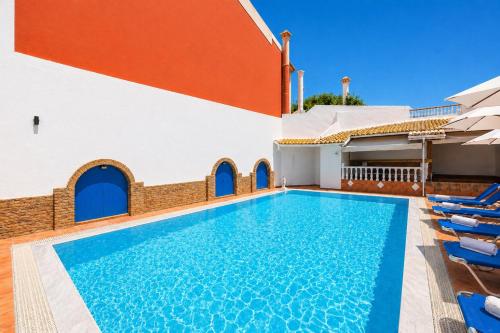 a swimming pool with chairs next to a building at Kavos Panorama Hotel in Kavos