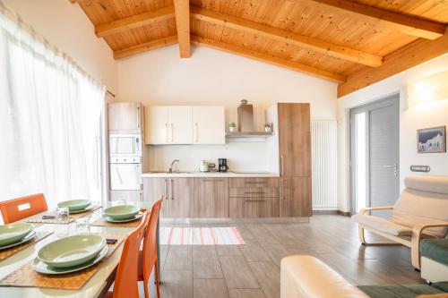 a kitchen and dining room with a table and chairs at Camping Italia 90 Apartments in Domaso
