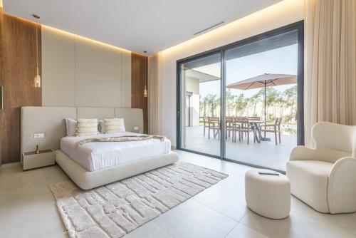 a bedroom with a bed and a chair and a table at Villa Milabel in Segraga