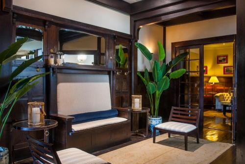 a living room with a bunk bed and a chair at Hotel Casa Higueras in Valparaíso