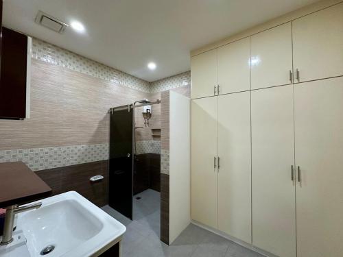 a bathroom with a sink and a shower at The Penthouse at Sapphire in San Agustin