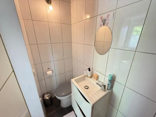 a small bathroom with a sink and a toilet at Studio cosy parking in Margny-lès-Compiègne