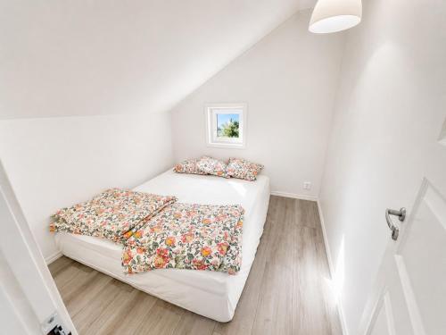 a small bedroom with two beds in a attic at The Pearl of Södertälje in Södertälje