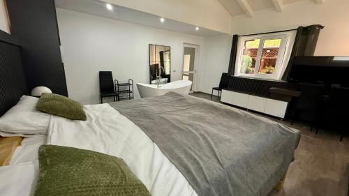 a bedroom with a large bed and a piano at Casa Ducaru Moieciu de Sus in Moieciu de Sus