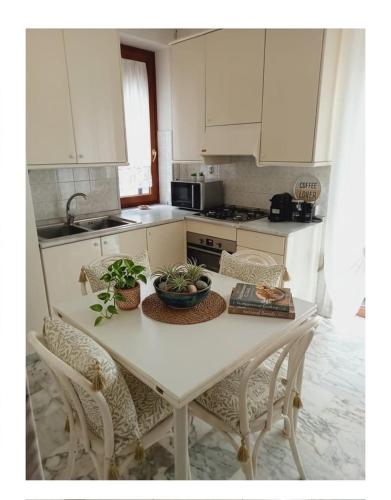 a kitchen with a table and chairs with plants on it at Miky M House in Venosa