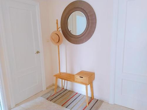 a mirror and a wooden table in a room at Hotel Rodeiramar in Cangas de Morrazo