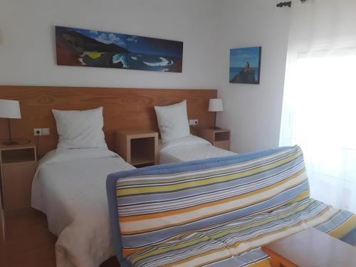 a hotel room with two beds and a blanket at Finca La Calera Lanzarote - Calma in Güime