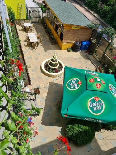 an overhead view of a garden plot with a green umbrella at Angely Summer Vila in Eforie Nord