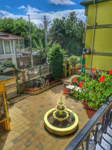 a garden with a miniature christmas tree on a balcony at Angely Summer Vila in Eforie Nord