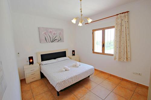 a bedroom with a bed with two towels on it at Marques - holiday home with private swimming pool in Benitachell in Benitachell