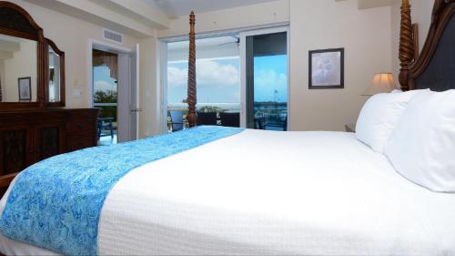 a bedroom with a large bed and a large window at 124 Mariners Club in Key Largo