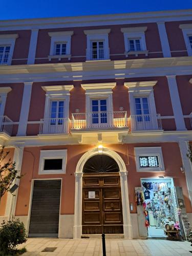 a large building with a door and a balcony at Antica Dimora Petito Luxury Suites in Matera