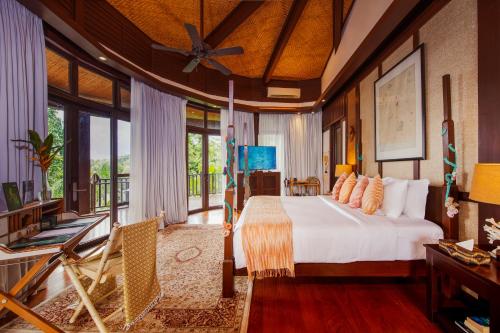 a bedroom with a bed and a balcony at Lihim Resorts in El Nido