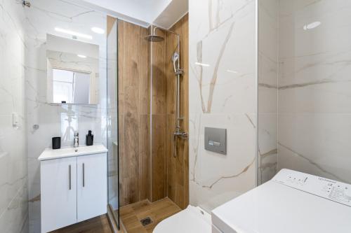 a bathroom with a shower and a toilet and a sink at Erato Residential Complex in Ofrínion