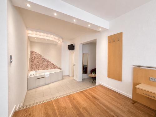 a living room with a wall of rocks at Hotel Wania in Hamburg