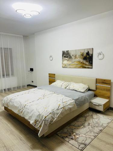 a bedroom with a bed and a painting on the wall at Casa Bradu in Mangalia