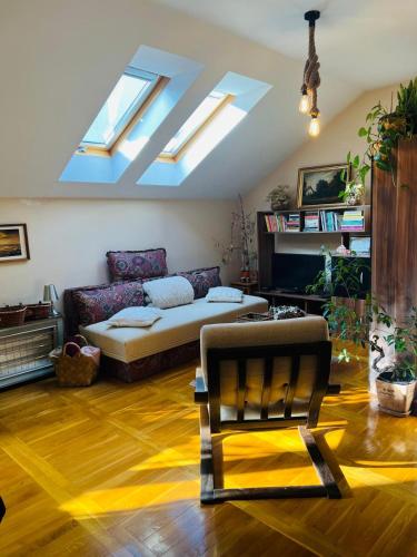 a living room with a couch and skylights at Apartman Zamak Sombor in Sombor
