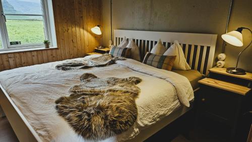 a bedroom with a bed with animals laying on it at The Forgotten Farmhouse in Skogar