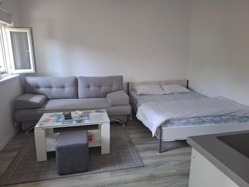 a living room with a couch and a coffee table at Eid in Mostar