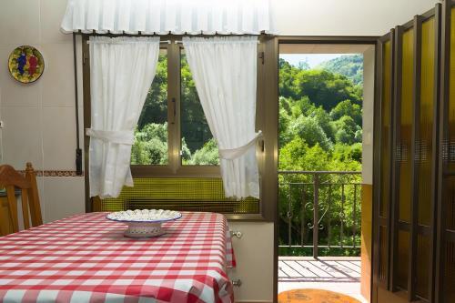 a table with a red and white checkered table cloth at La Veiga Apartamentos Turísticos in La Riera