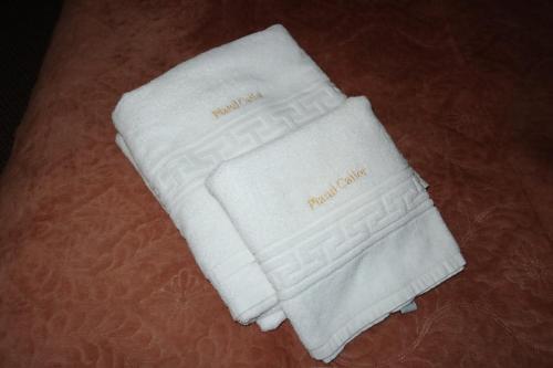 a pair of white gloves sitting on a bed at Casa Plaiul Cailor: Rustic Mountain Hideaway in Proviţa de Sus