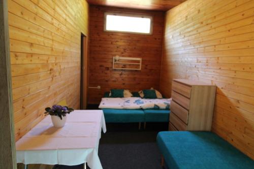 a room with two beds and a table in it at Chata Alenka in Štítary