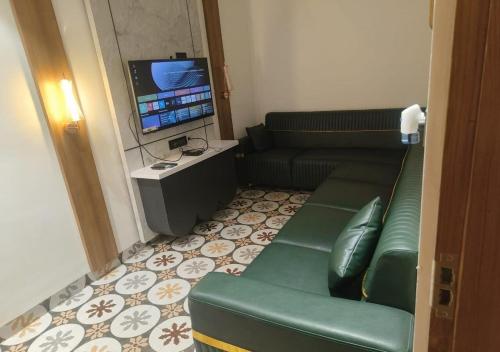 a living room with a couch and a television at K R GRAND in Vijayawāda