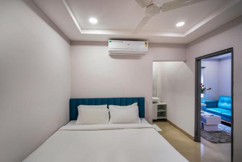 a bedroom with a bed with a blue headboard at New Prestige Hotel in Hyderabad