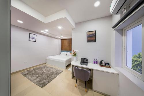 a room with a desk and a bed and a window at New Prestige Hotel in Hyderabad