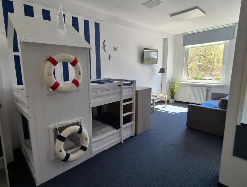 a childs bedroom with a bunk bed with a life preserver at AQUA HOUSE in Sopot